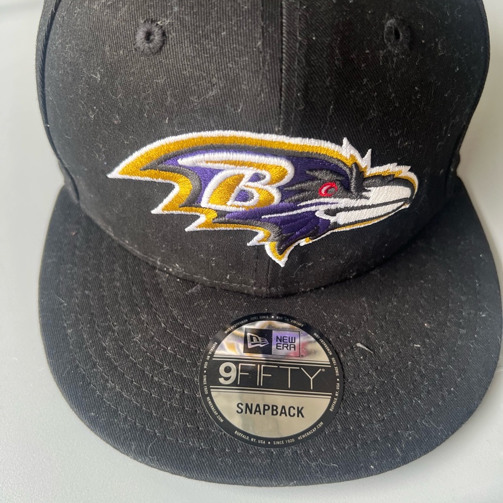 Baltimore Ravens New Era Black Snapback Hat with Purple and Gold Logo